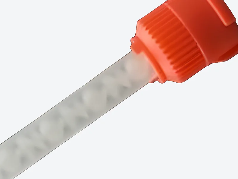 Show a close-up: Close-up of the orange bayonet inlet fitting and the white mixing elements inside the clear tube
