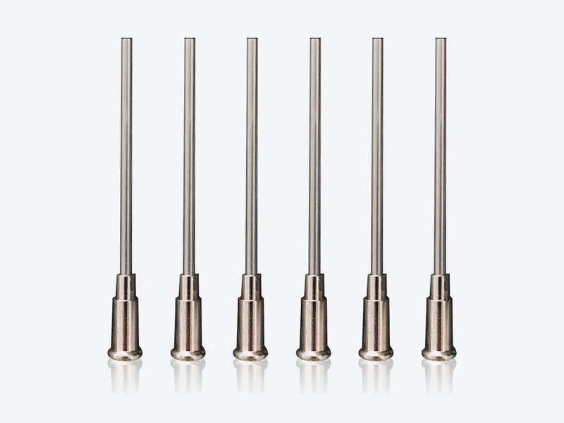 Six long metal needles on small flared metal bases