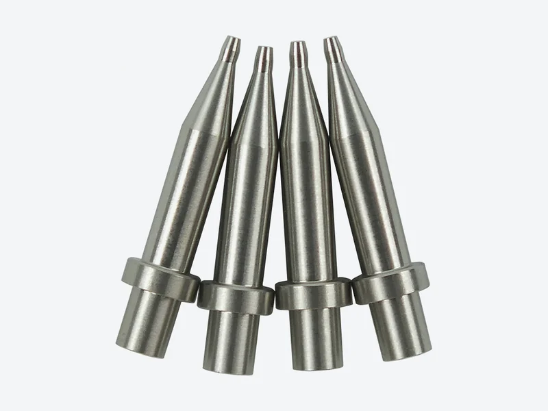 Four stainless steel split-type machine dispensing tips with long tapered outlets and a collar